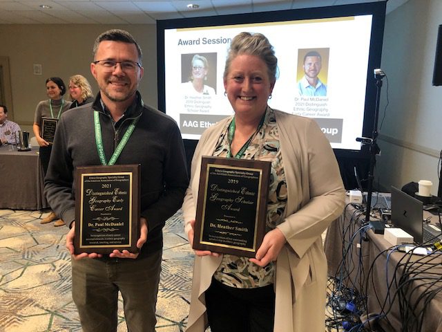 Dr. Heather Smith and Dr. Paul McDaniel holding EGSG awards